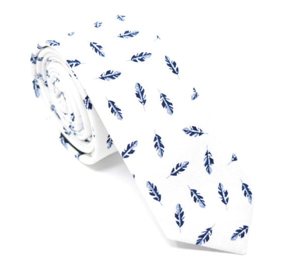A handmade, white tie with small navy feathers scattered on the tie.