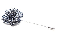 A black and white flower lapel pin for a suit.