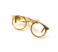 Polished gold glasses tie clip.