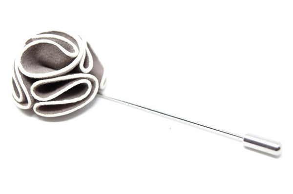 A grey and white lapel pin for a suit.