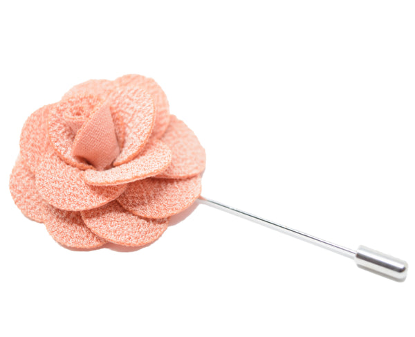 A large blush flower lapel pin for a suit.