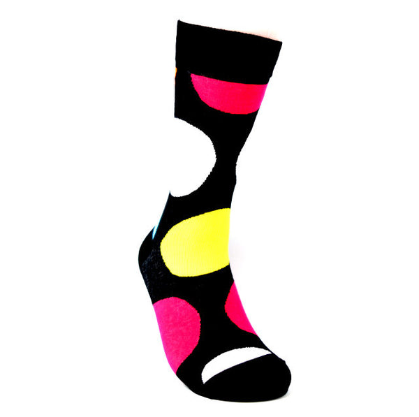 Black sock with large yellow, white and pink polka dots.