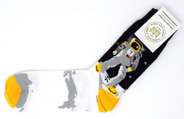 white, yellow, black, and grey socks with an astronaut.