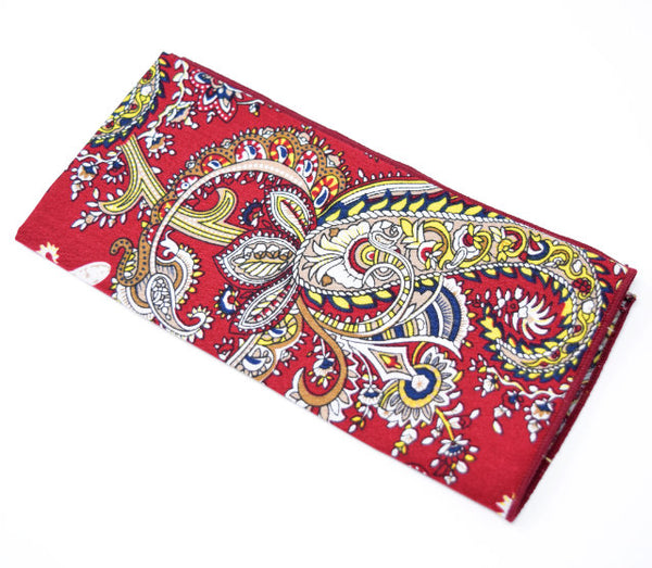 Mardi Gras Beads is a red pocket square with gold and navy paisley.