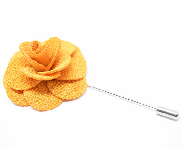 A large golden yelow flower lapel pin for a suit.
