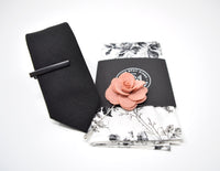 This pre-styled box has a black tie, black tie clip, rose lapel flower and a black and white floral pocket square.
