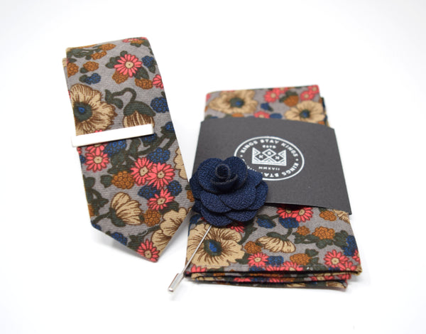 This pre-styled box has matching floral tie and pocket squares, a navy blue flower lapel pin, and a polished silver tie bar.